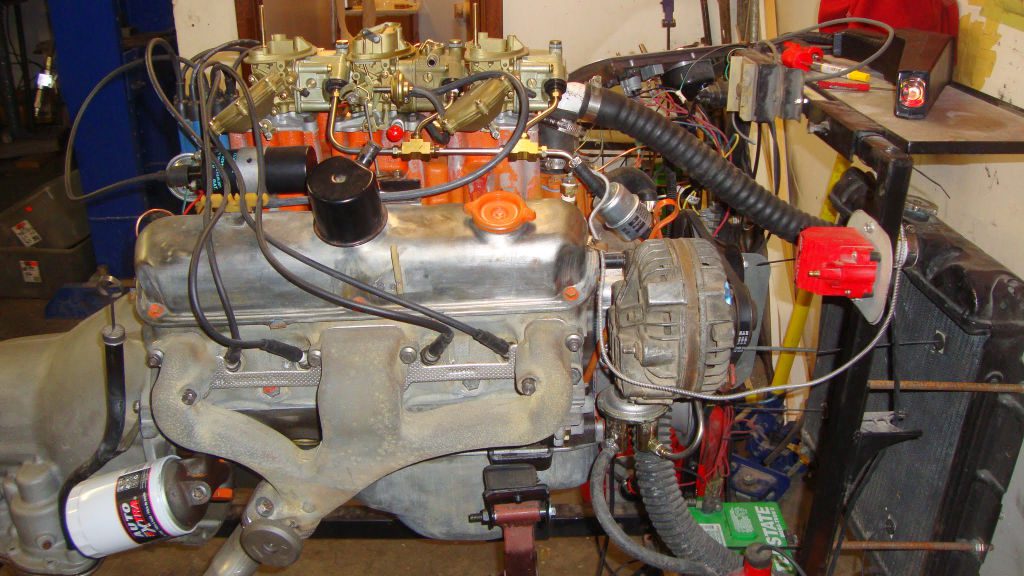 Photo of a 340 engine and 6-bbl carburetors from a 1970 Plymouth AAR Cuda on a run stand